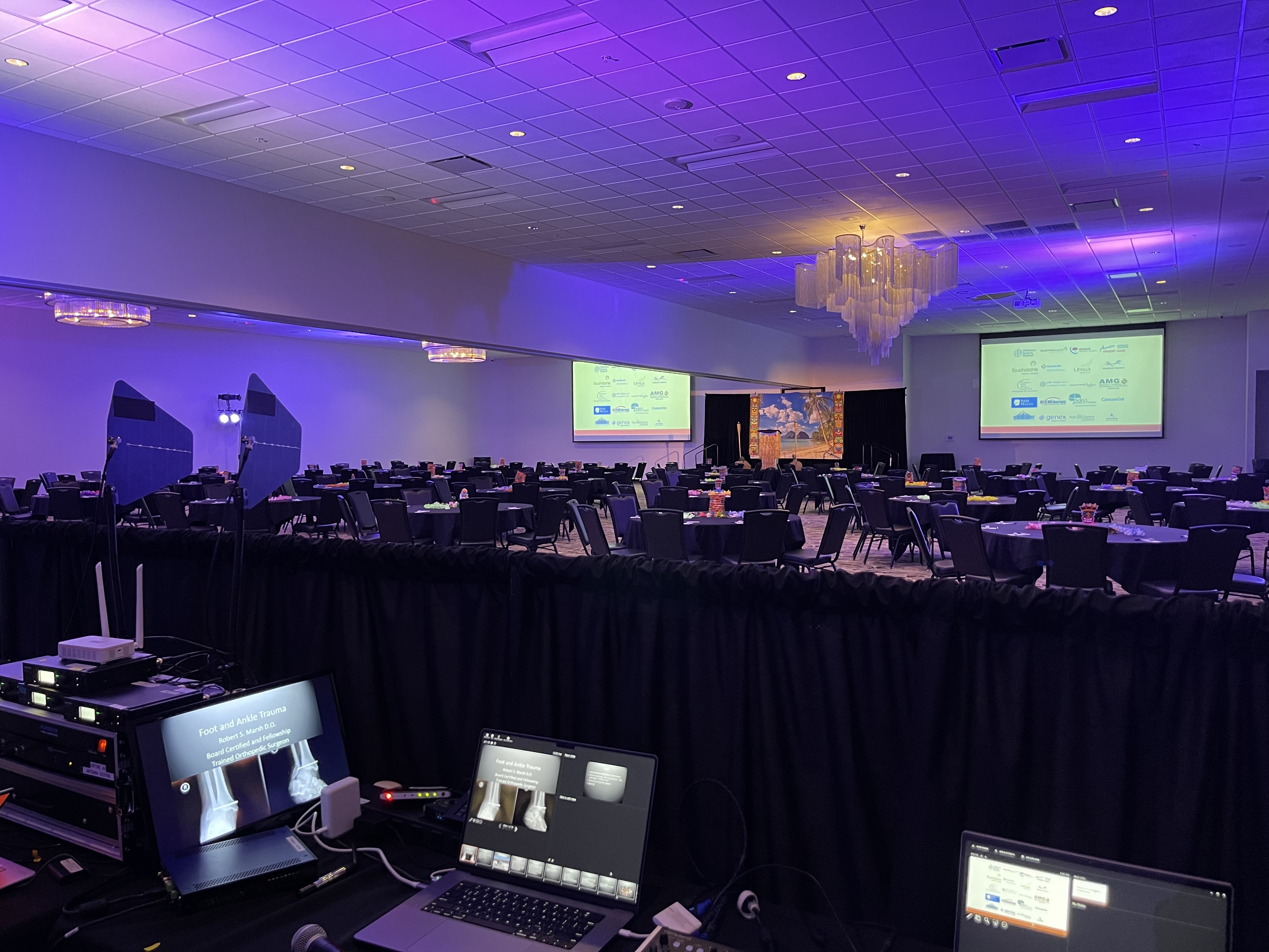 Ballroom with purple uplighting and dual screens