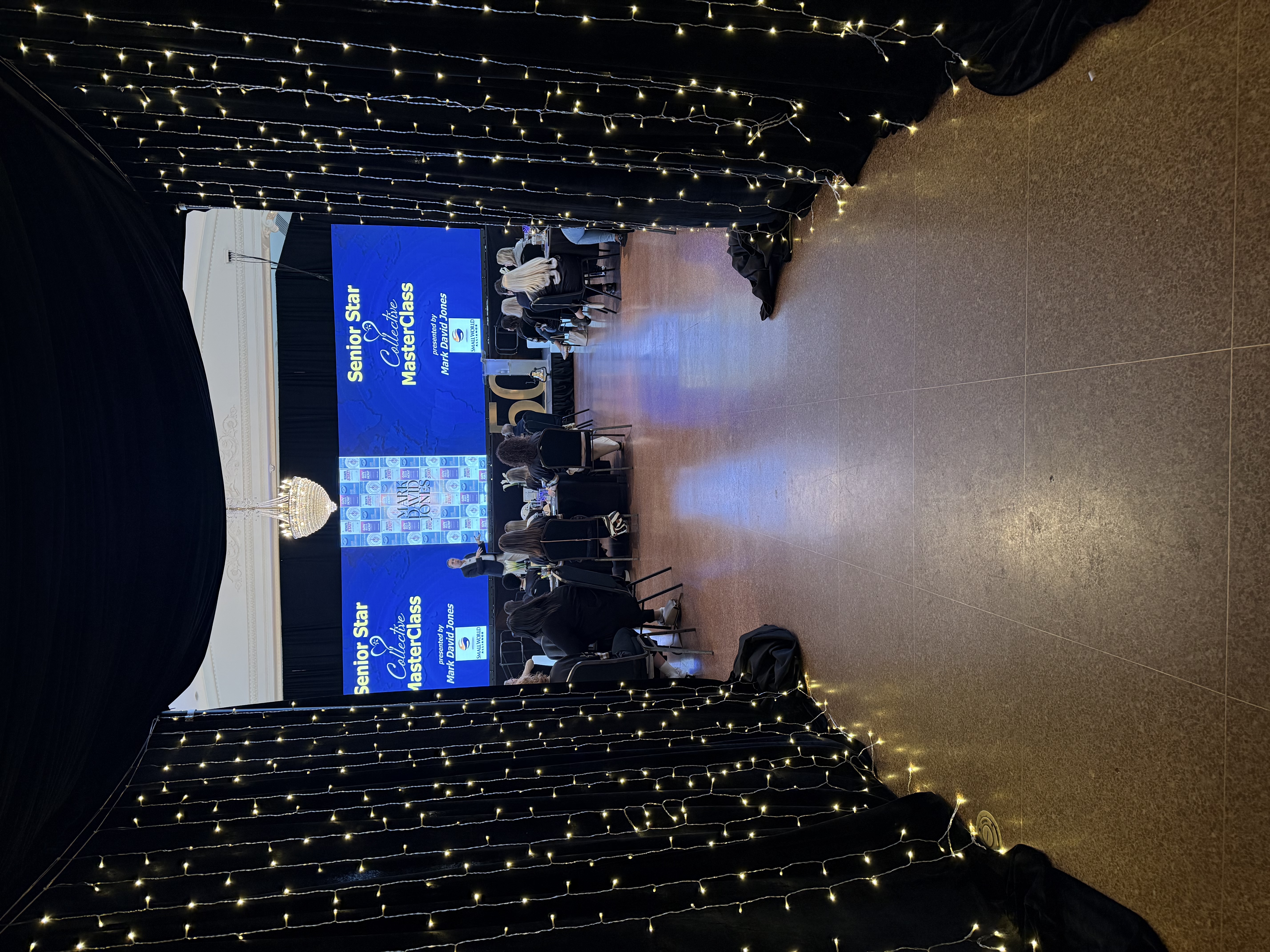 MasterClass event with dual screens and string lights