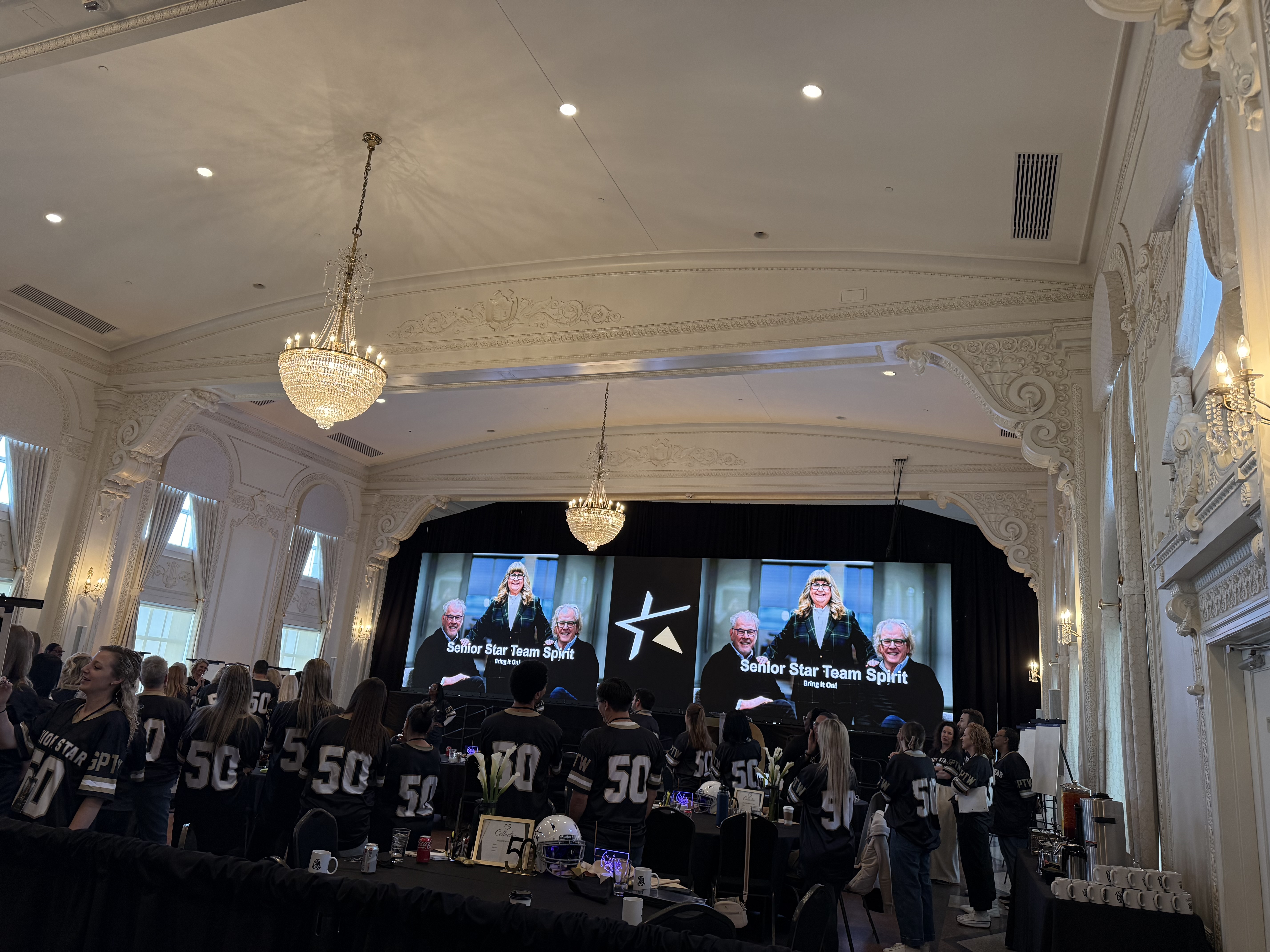 Triple screen setup in ornate ballroom